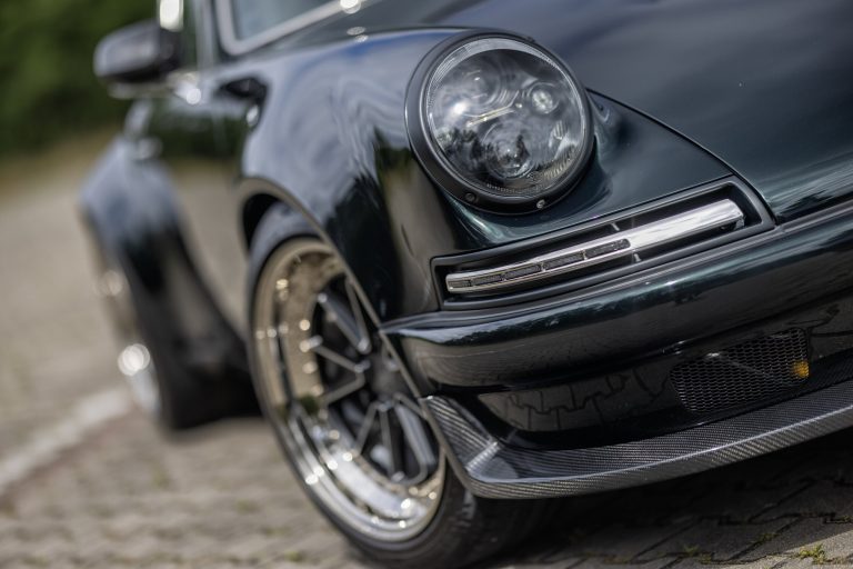 Front end of RCR Porsche 911 restomod with LED headlight and carbon front splitter