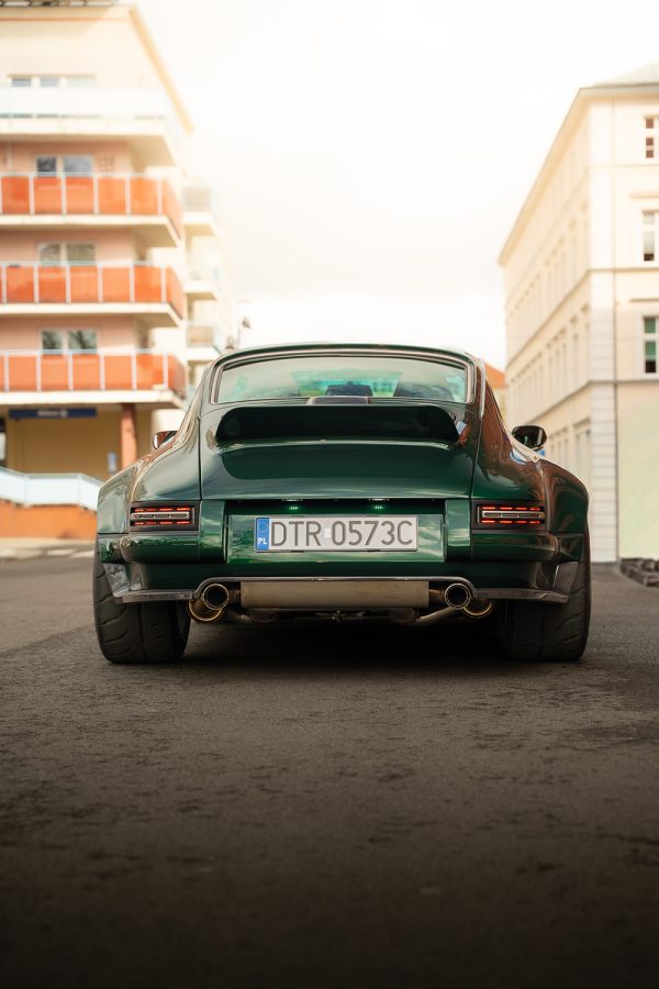 The wide stance and raw exhaust hint at the deep, bass-heavy sound of the air-cooled boxer engine.