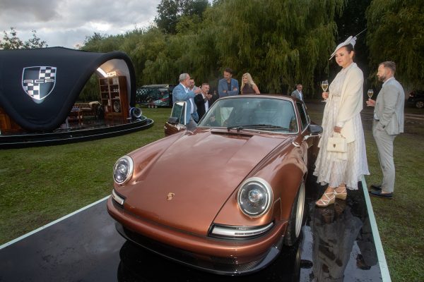 RCR Porsche 911 restomod presented during a lifestyle event, blending classic design with contemporary elegance