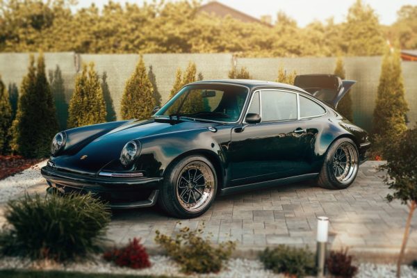 RCR restomod Porsche 911 with open door revealing bespoke interior and lightweight sport seats